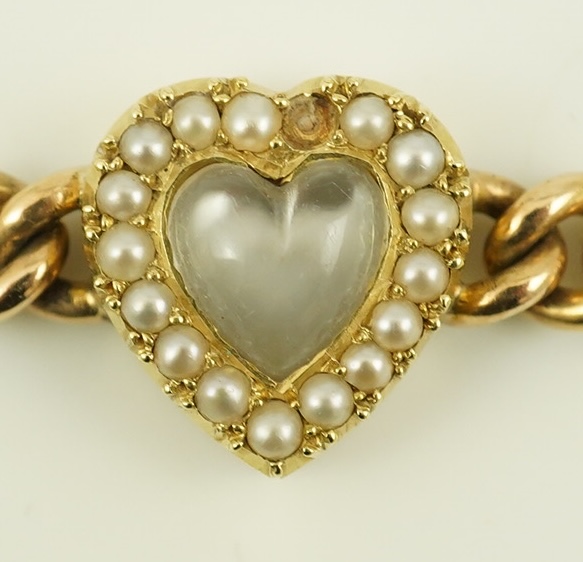 A late Victorian 15ct gold curb link bracelet, with central moonstone and seed pearl set heart shaped motif